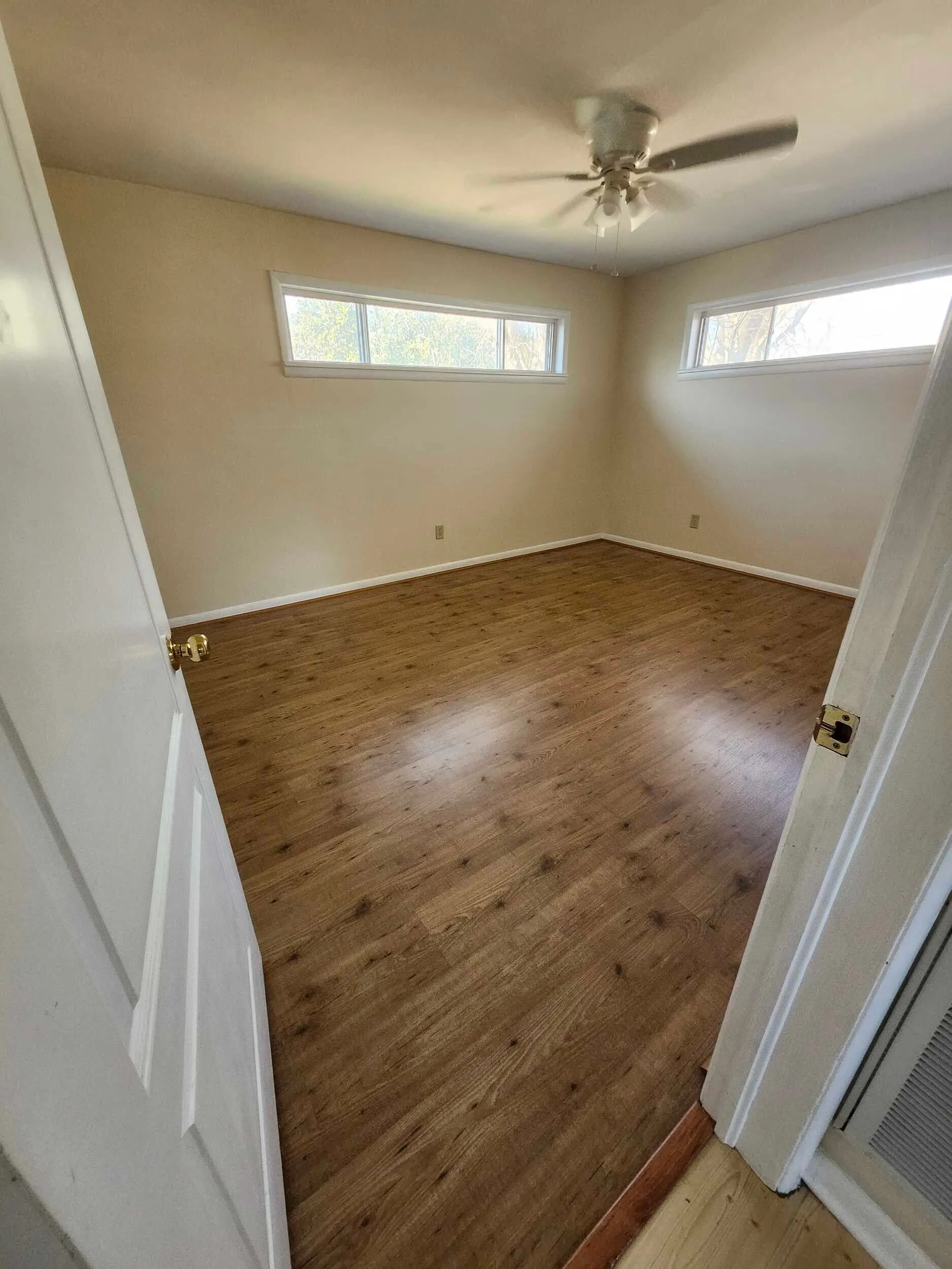 Brickstone Square interior room with a ceiling fan and wood flooring